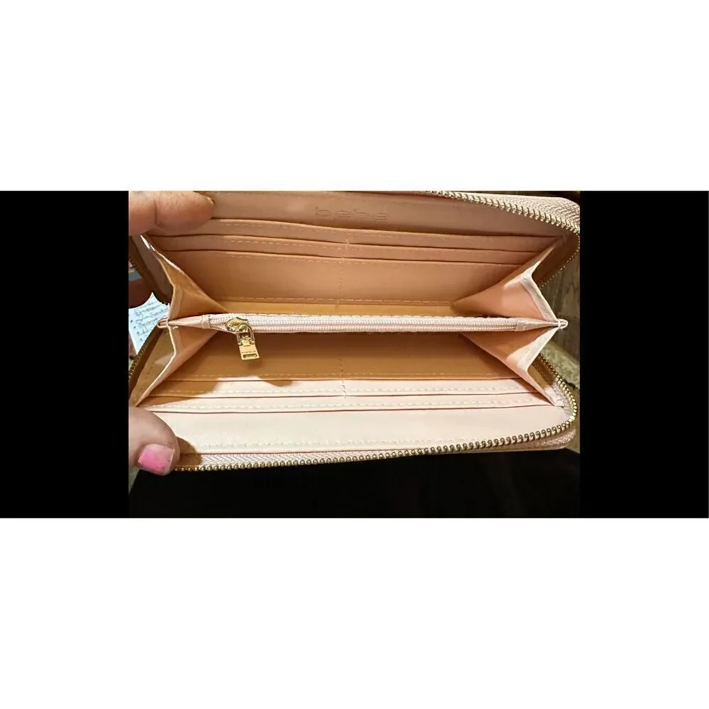 BEBE Pink and gold, large wristlet. Lots of room never used.